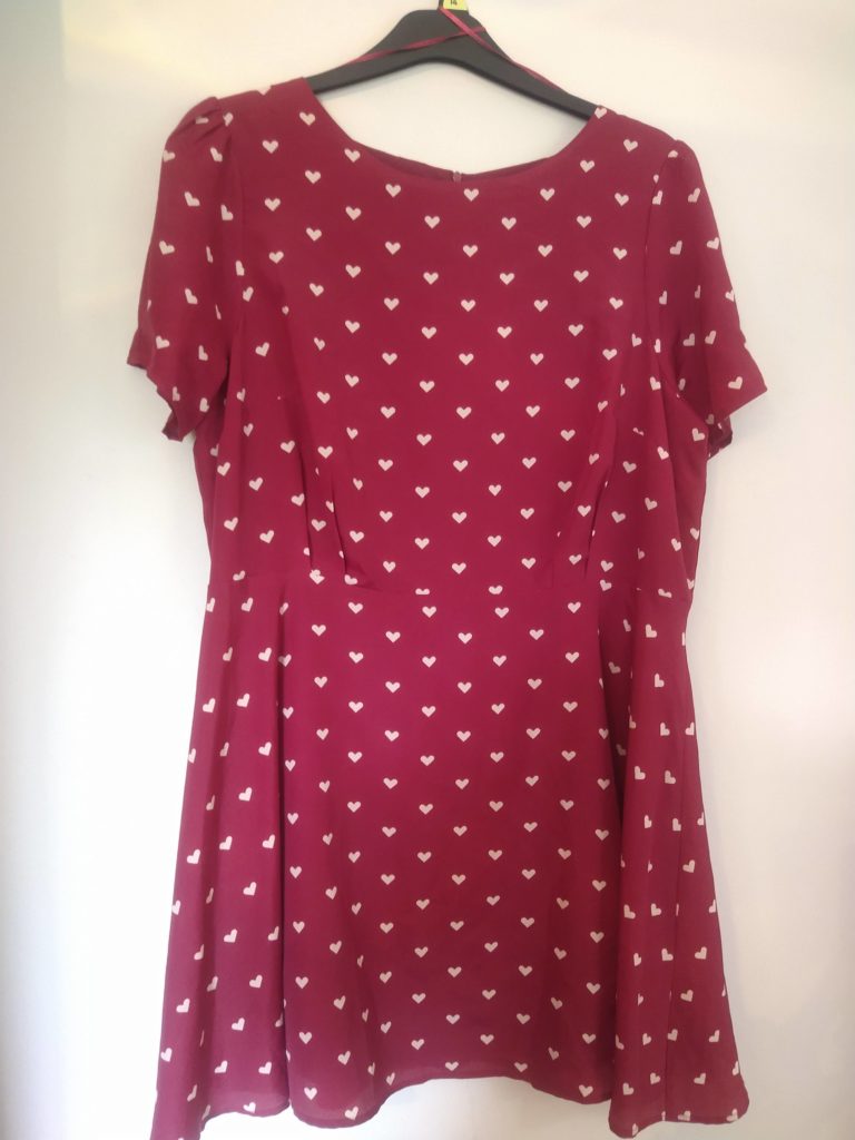 A dark pink skater dress with hearts